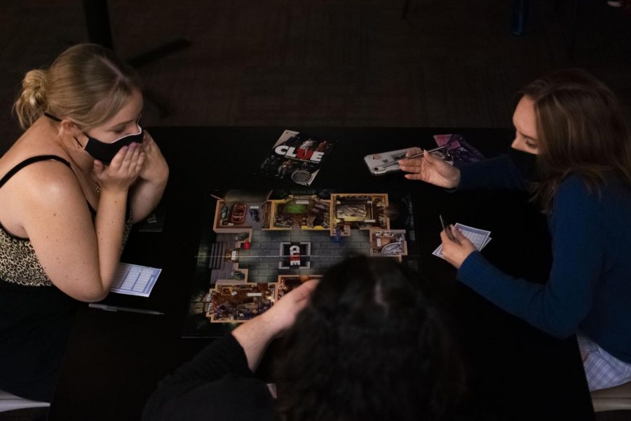Students play Clue in the Carriage House. 
Photo Credit: Lilly Kubit