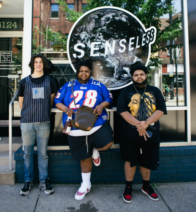 Cole Modell, left, stands outside Senseless with owners Javed Watson, middle, and Rome Watson, right. Photo Credit: Jake Lach