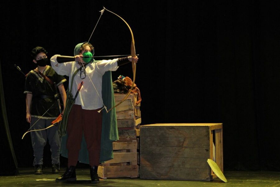 Leo Liotta ‘23, as Robin Hood, takes aim during the first act of “Robin Hood.” Photo credits: Chatham University Drama Club