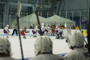 Chatham men’s ice hockey in action at Hunt Armory, with makeshift tent locker rooms in the background. Photo Credit: Liam Lyons for Chatham Athletics