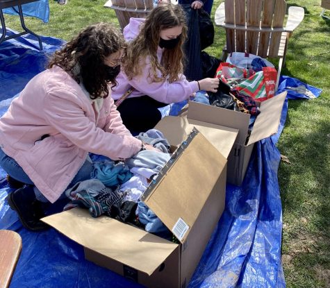 Members of Chatham Student Power look through bins of clothing at last years fair. Photo Credit: Moe Williams 