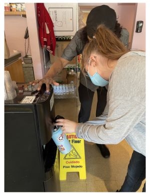 Students struggle to use water bottle filling stations in Cafe Rachel. Photo Credit: Michaela DeLauter