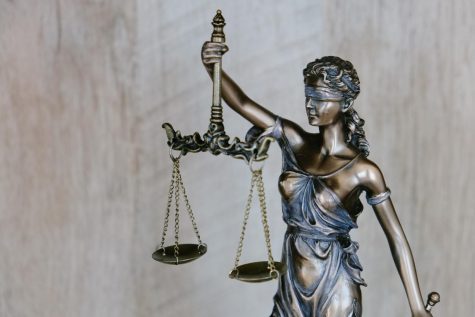 Lady Justice holding a set of scales. Photo credit: Unsplash