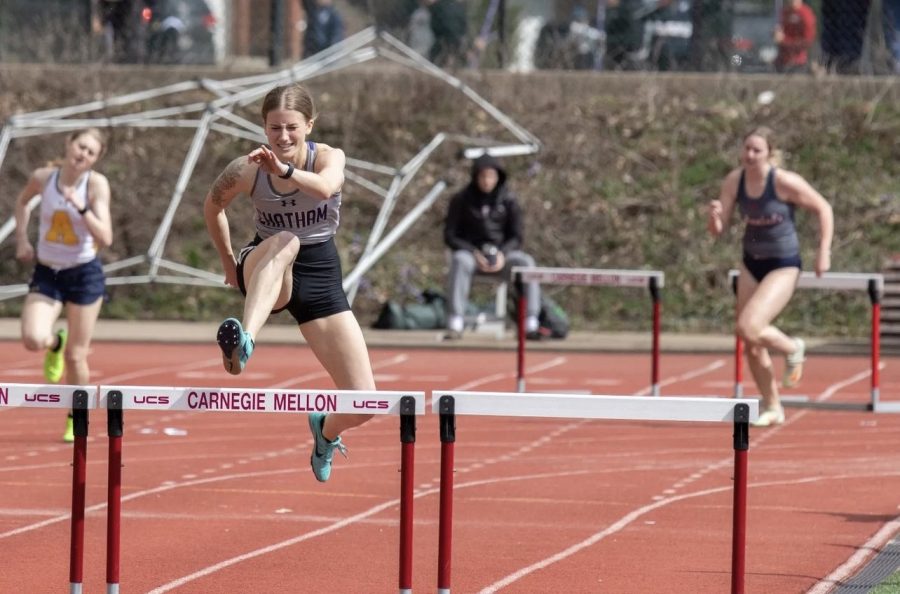 Graduate student Carlee Domke hurdles during race at Carnegie Mellon University. Photo Credit: Chatham Athletics