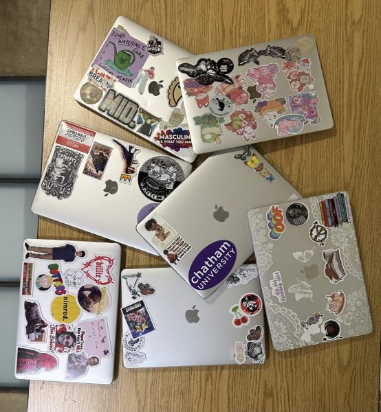Student laptops with a range of various stickers displayed. 