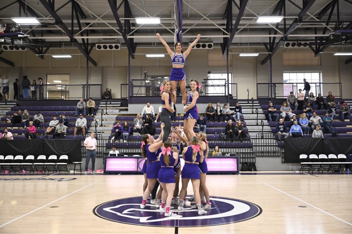 Cheer+team+performs+tower+stunt+during+stoppage+of+basketball+game.
