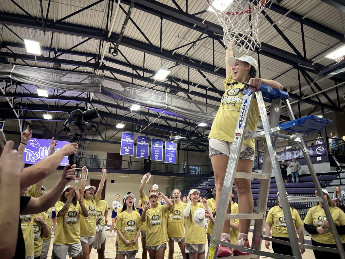 Ashlie Louden 25 cuts the net after their 77-50 victory.