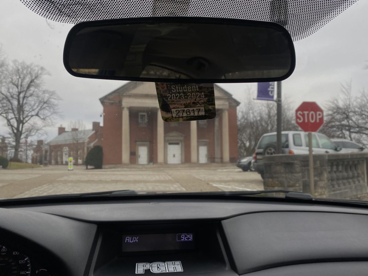 Car dashboard displaying student parking pass at the Campbell Memorial Chapel. 