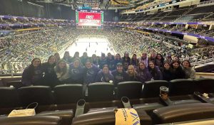 Women's hockey team poses at PWHL game on March 17. Photo provided by women's hockey team