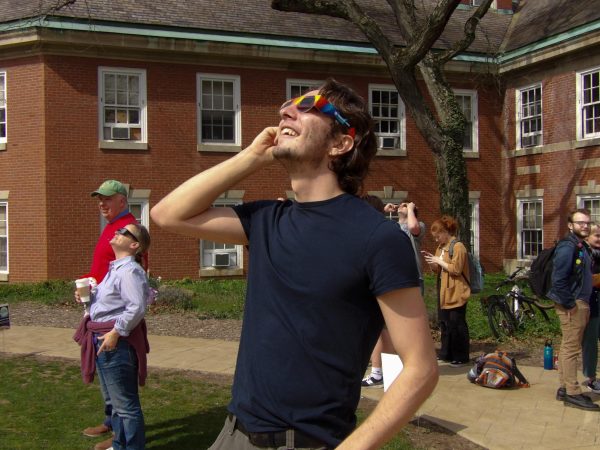 Ben Bashioum ‘25 observes the eclipse with special glasses at the Shadyside campus.
