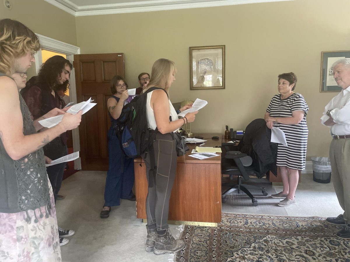 Graduate student Lindsey Disler, surrounded by Chatham Students United members, reads from the groups list of demands at the Presidents office.
