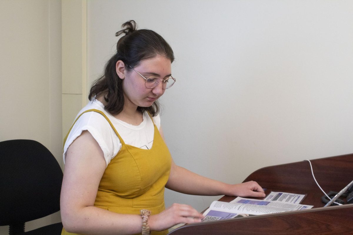 Bella White '27 looks over the first issue of the Communiqué at a pitch meeting on Sept. 17, 2024.