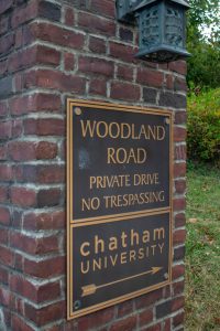 Sign at the entrance of Woodland Road. 
