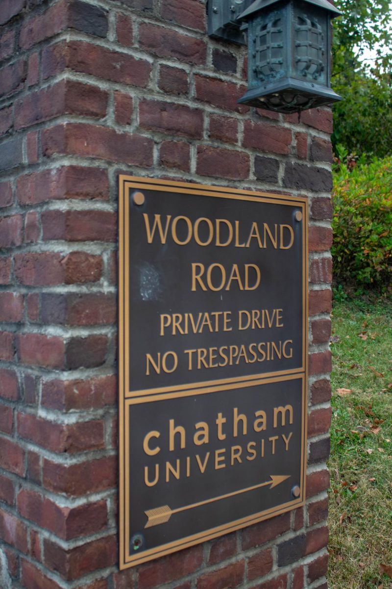 Sign at the entrance of Woodland Road. 