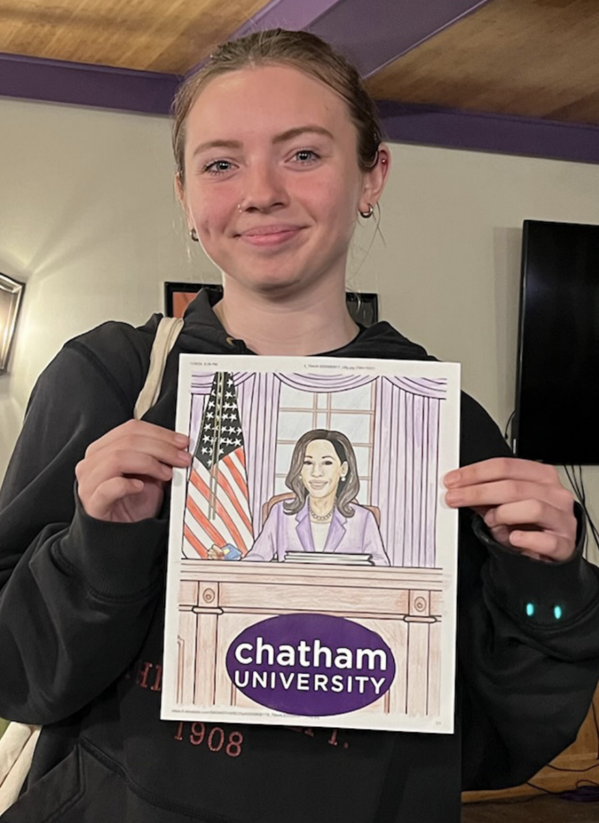 Anna Mack ‘27 with a drawing of Vice
President Kamala Harris at the Chatham
Feminist Coalition’s coloring night, where students shared their feelings on gender equality and politics.