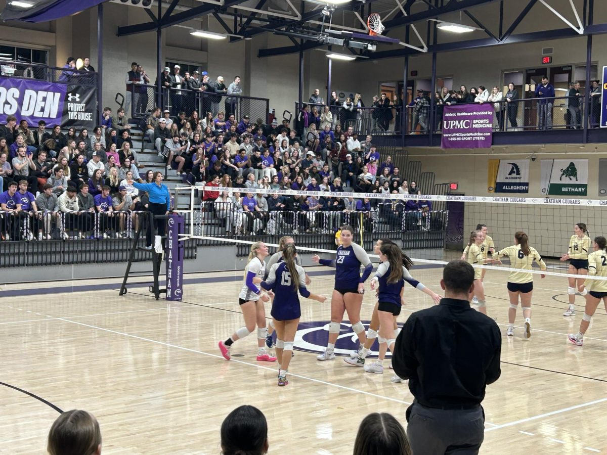 The women's volleyball team celebrates a point in the first round of the PAC playoffs against Thiel College on Nov. 12