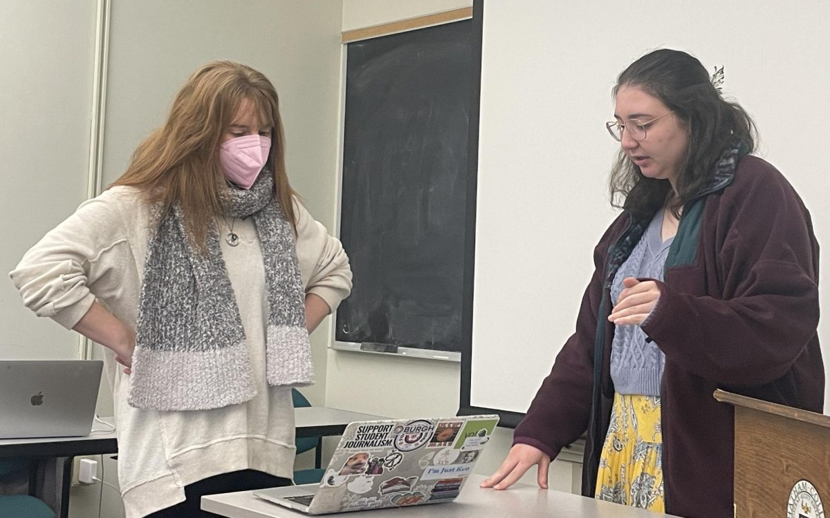 Sara Bauknecht helps Bella White '27, the Communique's editor-in-chief, edit the print layout for the final issue of fall 2024.