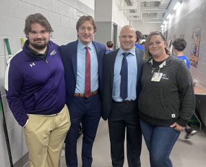 Men's ice hockey equipment manager Ryan Preston '25, Ryan Miller '25, head coach Michael Gershon and athletic trainer Rebecca Kayda pose for picture at UPMC Lemieux Sports Complex. Photo courtesy of Ryan Miller.