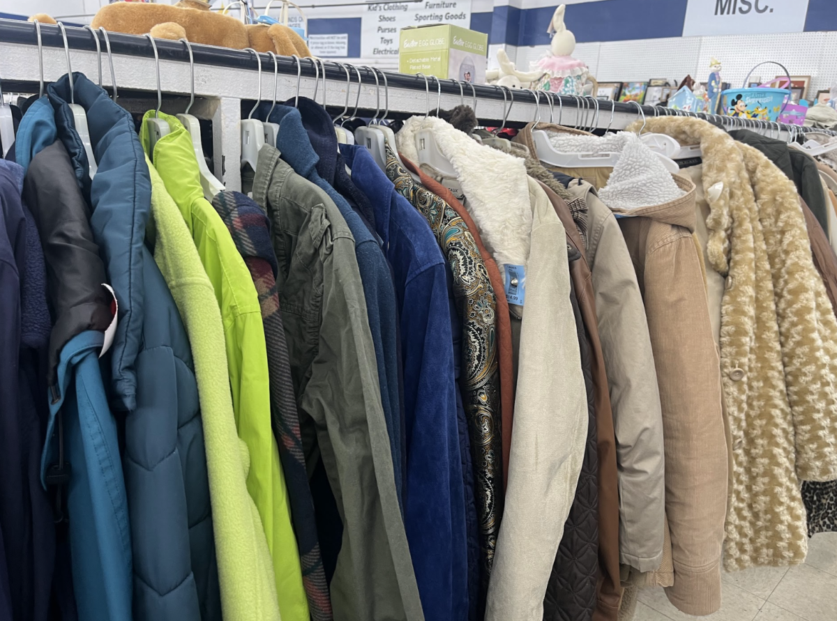 Clothes on a rack in a thrift store.