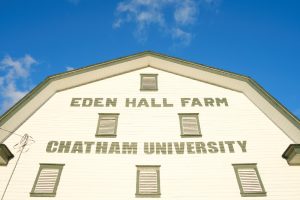 The sun shines on the barn at the Eden Hall campus. 