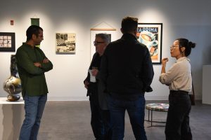 Michael Boyd, Rich Brown, Mike Bender, and Lin Qian talking during the opening ceremony of the Faculty Art Exhibition on Thursday Sept. 25.