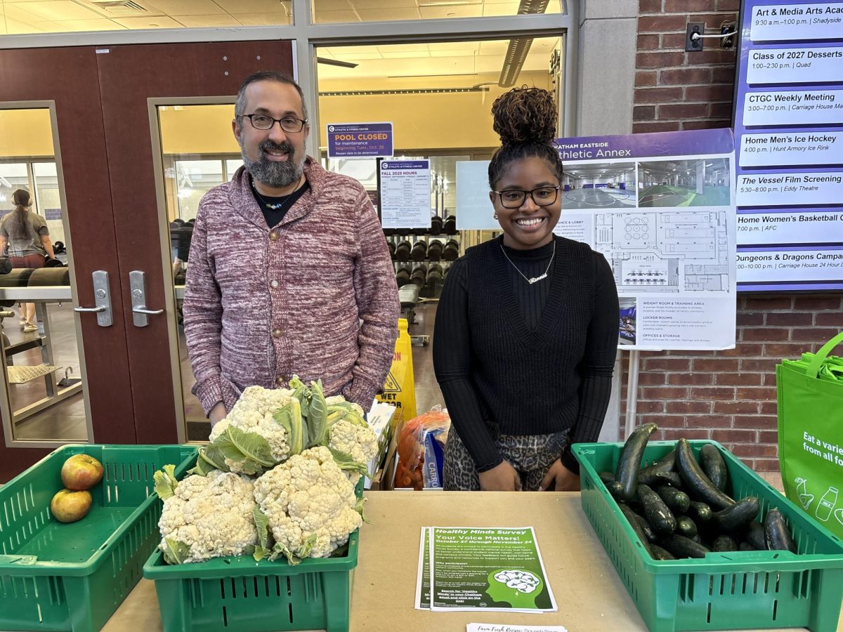 Executive Admin to the Dean of Students Josh Harris, left, and Karinne Barrett ‘26 help to distribute produce on Nov. 13 at the Athletic and Fitness Center (AFC).