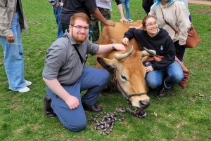 Moo the Cuddle Cow cuddles with Communiqué Visuals Editor Kyle Ferreira ‘25 (left) beside the pond in April 2025 during finals week. It was the last time that Moo visited the Shadyside
campus to help students to destress. Photo courtesy of Kyle Ferreira.