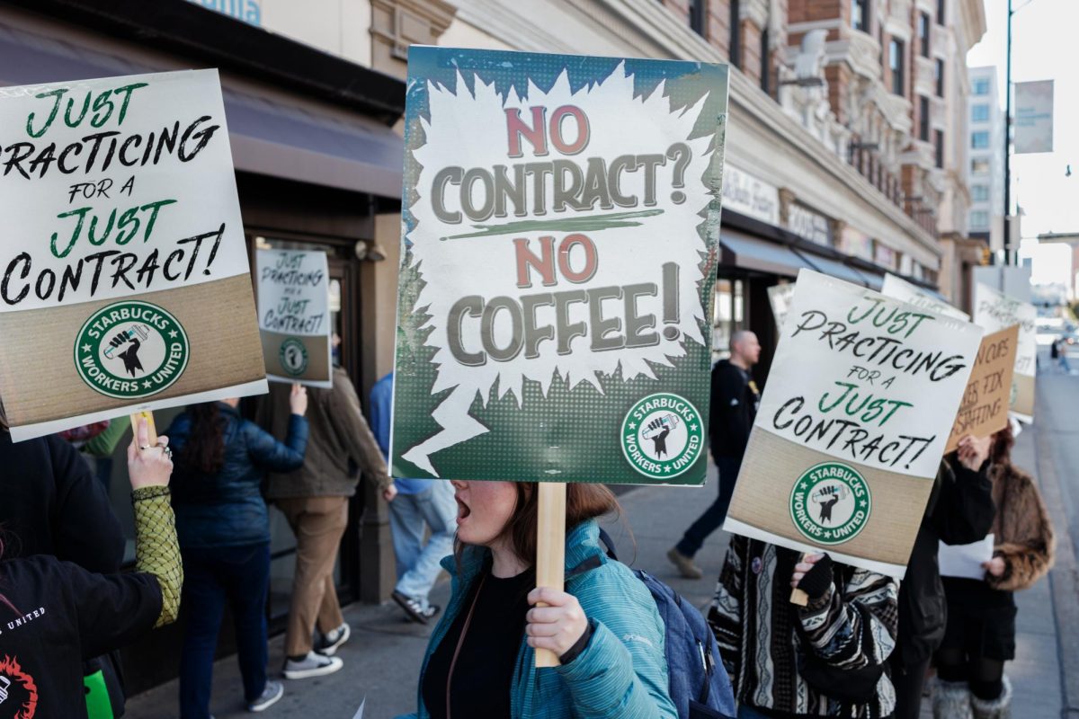 Starbucks workers and union supporters gather Oct. 26 outside Starbucks on Forbes Avenue in Oakland as part of a national day of picketing by Starbucks Workers United.