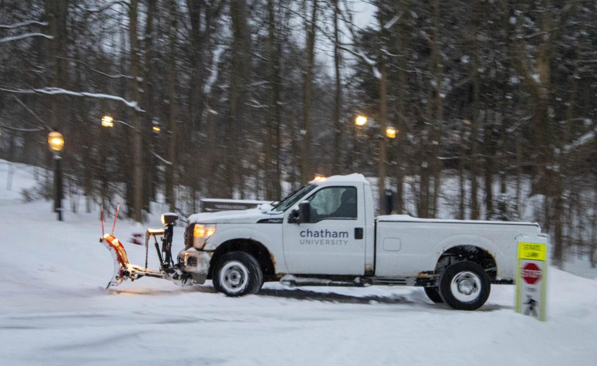 A Chatham plow truck works on clearing Woodland Road during a snow storm.