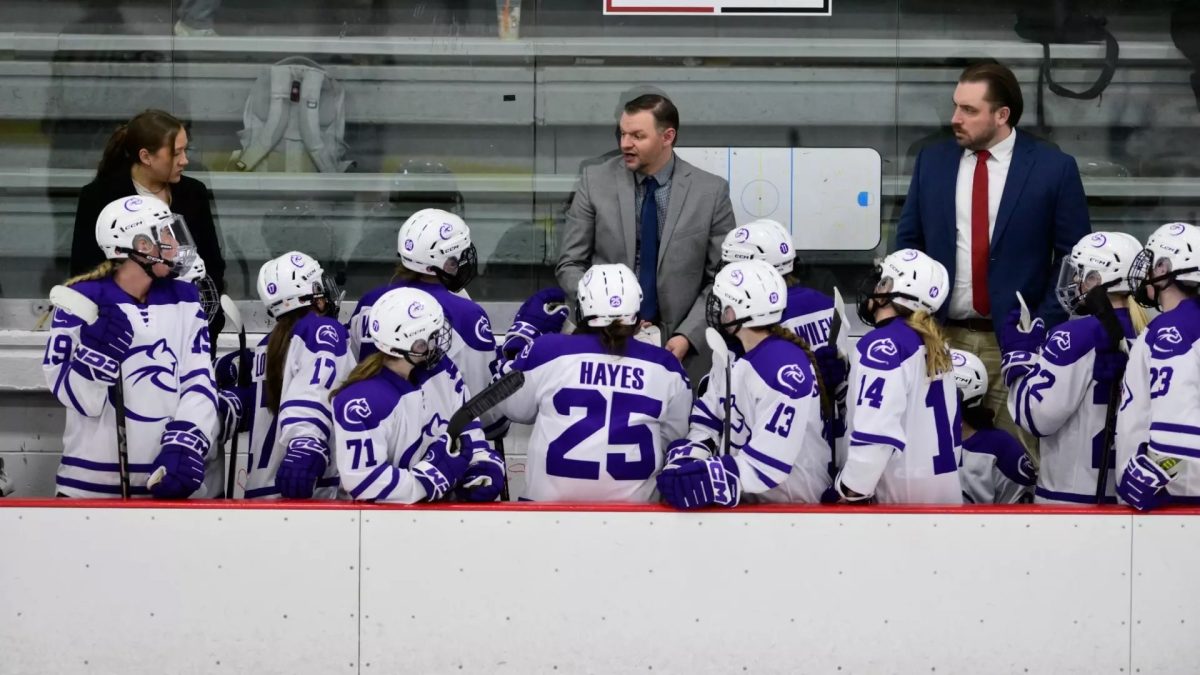 The Chatham women's hockey team huddles during a game. Photo credit: Chatham Athletics