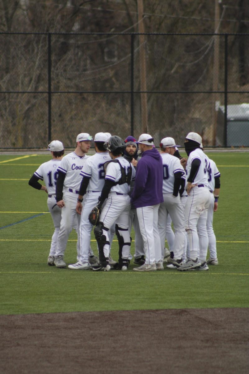 The Chatham men's baseball team huddles during a game. Students can work closely with Chatham sports team to gain hands-on experience with athletes and coaches.