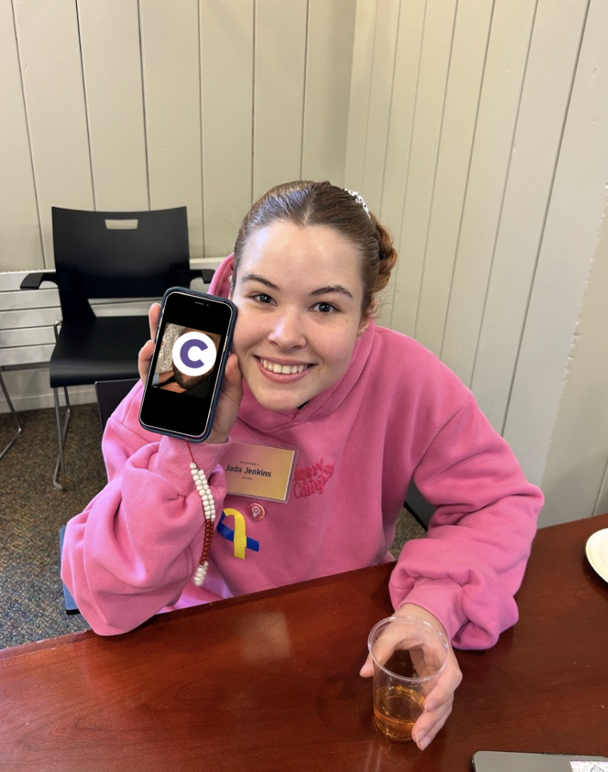 Jada Jenkins ‘26 holds a picture of her absent father with the Chatham logo covering his face. Photo courtesy of Jada Jenkins